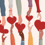 Concept of charity donation and help or social assistance.Voluntary hands that donate a heart to other hands as a metaphor for charity and contribution.Social work and voluntary work. Ngo